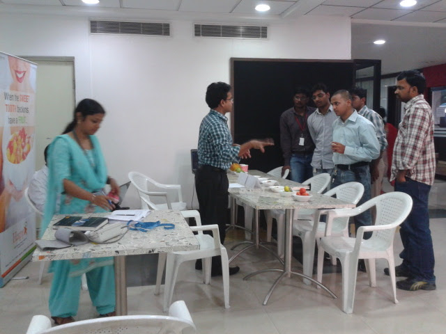 Hands-on food and nutrition demonstration at a cafeteria fruit table